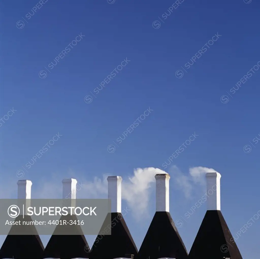Fumes emitting through chimneys, close-up