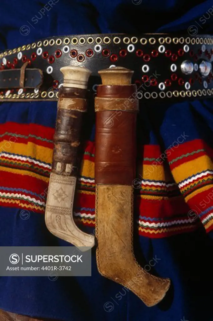 Traditional Sami dress and knives detail.
