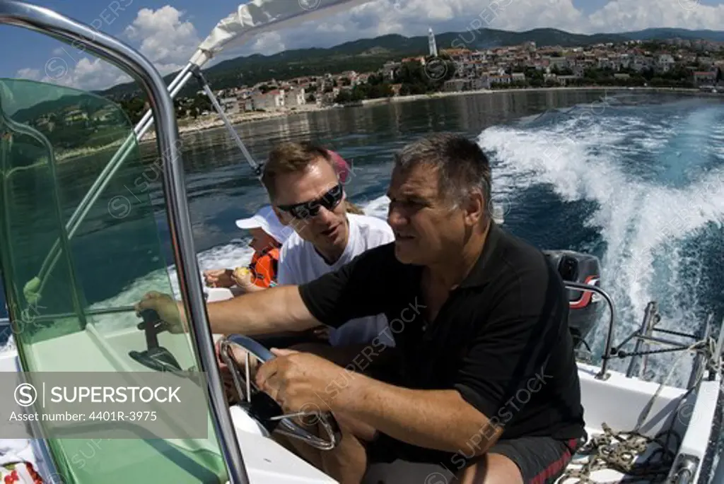 Two men in a motorboat.