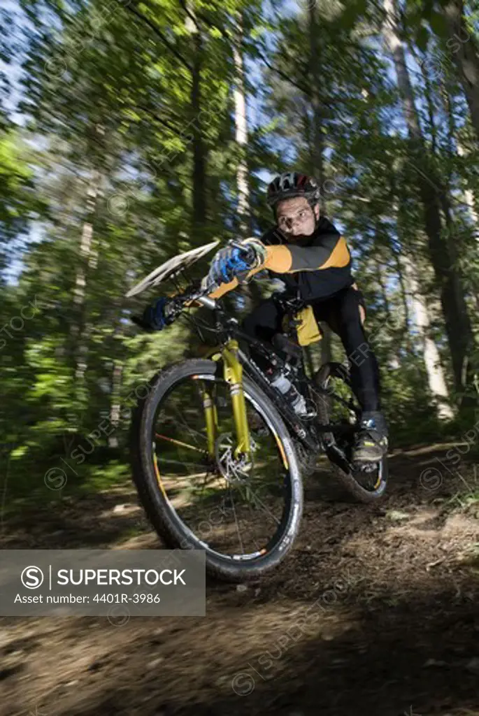 A person on a mountainbike in the forest, Sweden.