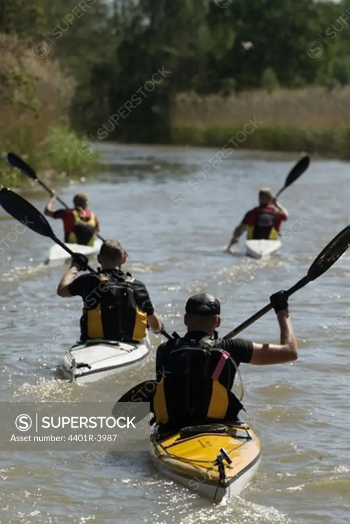 Paddlers in a canal, Sweden.