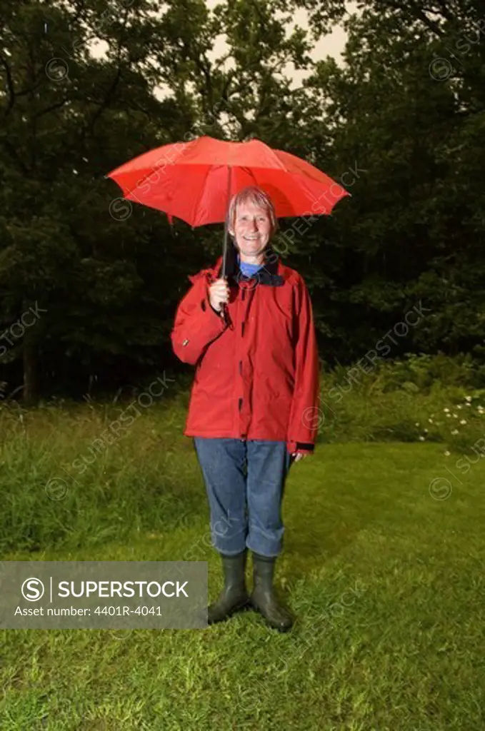 A woman with a red umbrella, Sweden.