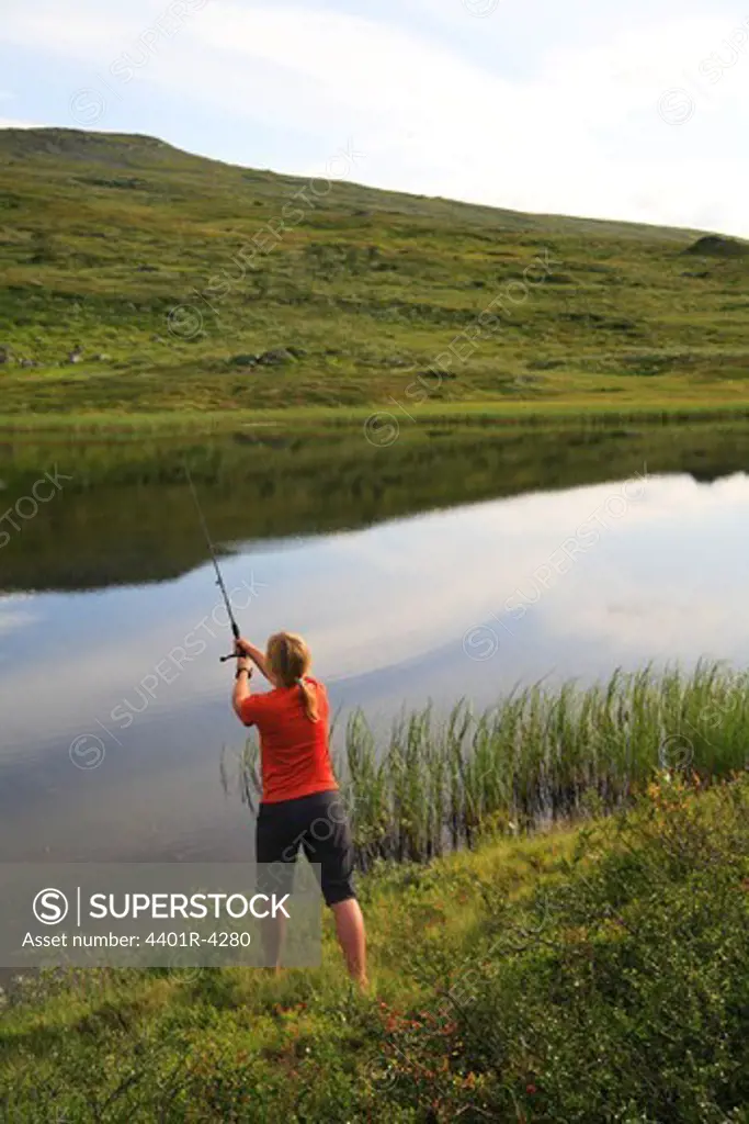 A woman fishing, Sweden.