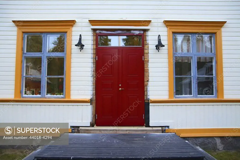 A red door on a white house.