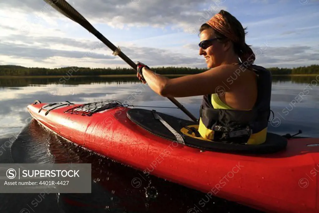 A woman canoeing, Norrbotten, Sweden.