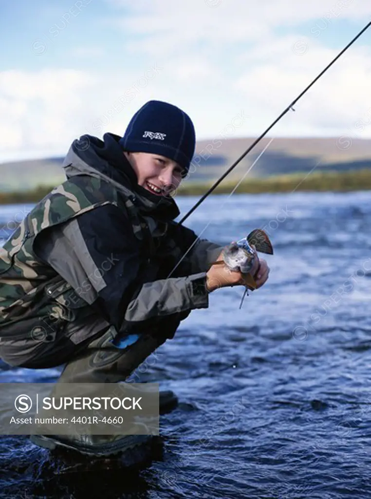 A boy fly-fishing, Lapland, Sweden.
