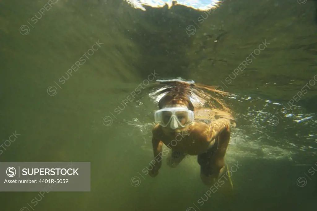 A boy swiming under water