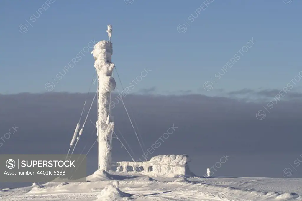 A pylon on a snow covered mountain, Sweden.