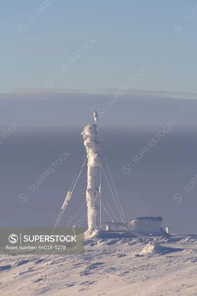 A pylon on a snow covered mountain, Sweden.