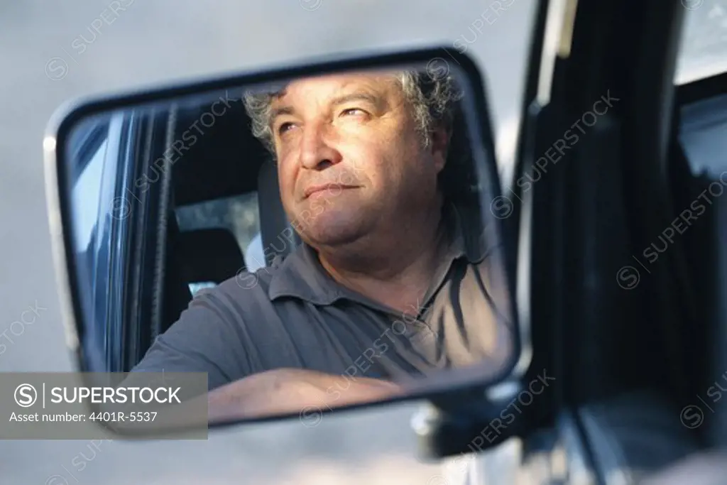 A reflected image of a man in a wing mirror, Spain.