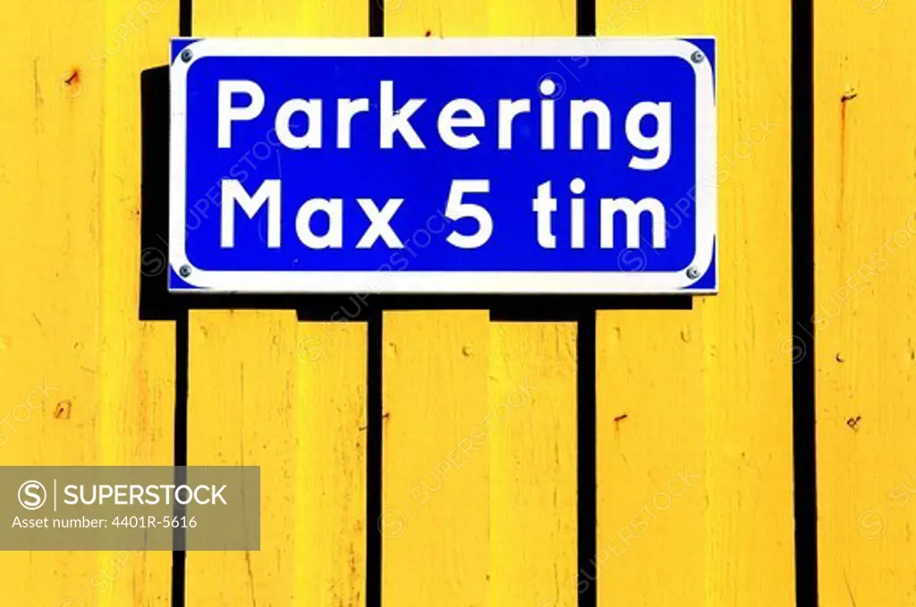 A parking sign on a yellow wall. Sweden.