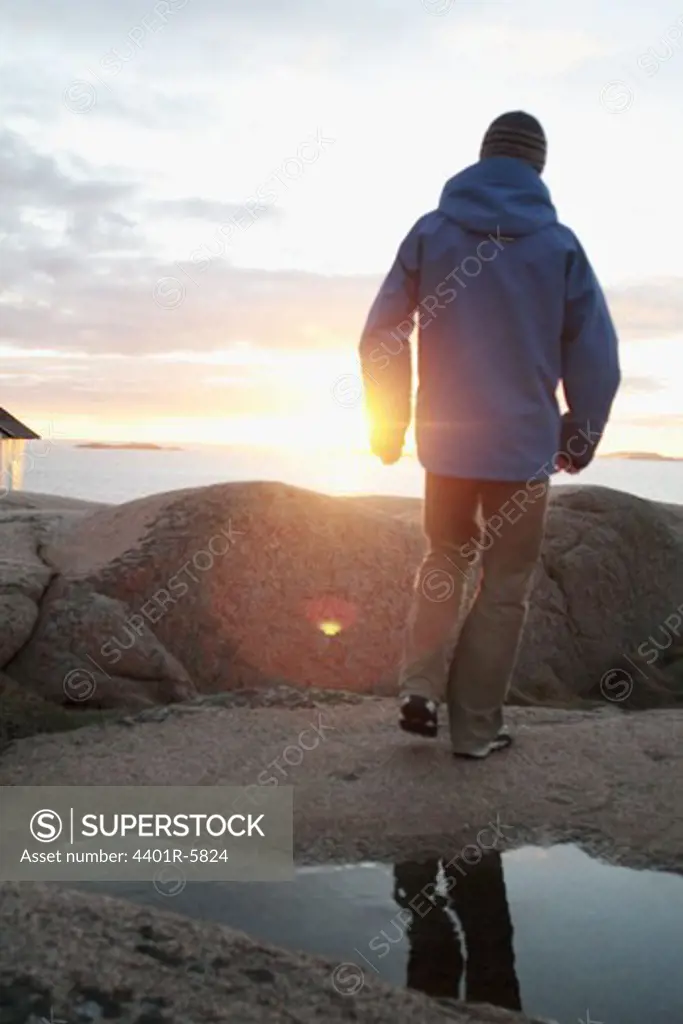 A man watching the sunset, Bohuslan, Sweden.
