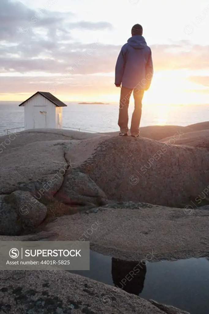 A man watching the sun go down, Bohuslan, Sweden.