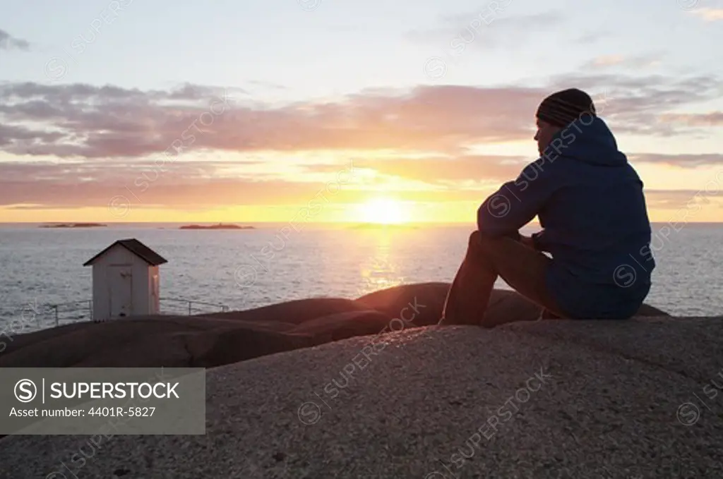 A man watching the sunset, Bohuslan, Sweden.