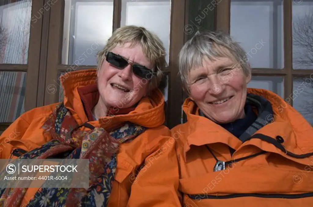 Porttrait of two smiling elderly women on ski vacation, Sweden.