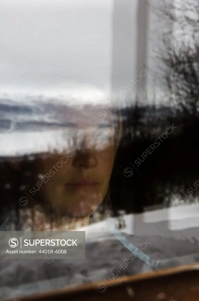 Portrait of a woman through a window.