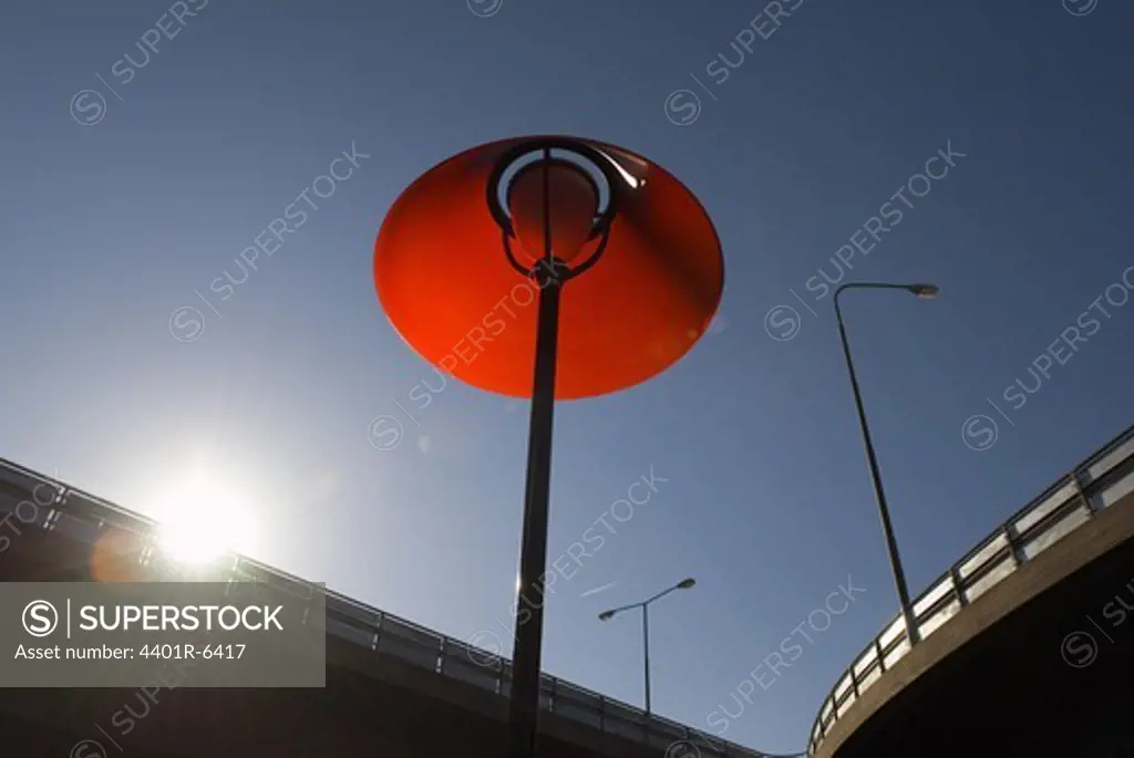 A red outdoor lamp by a viaduct, Stockholm, Sweden.