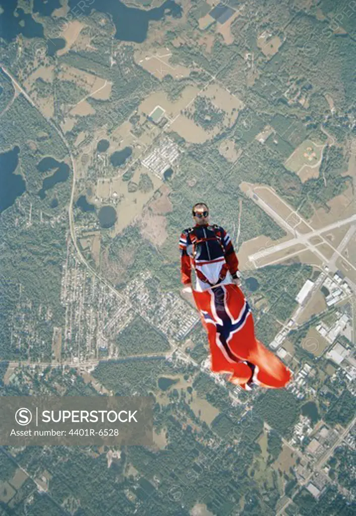 A parachute jumper holding a Norwegian flag, USA.