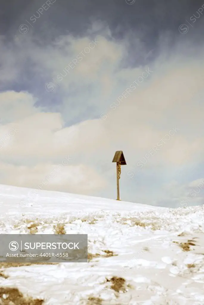 A Jesus cross in the snow, Trentino, Italy.