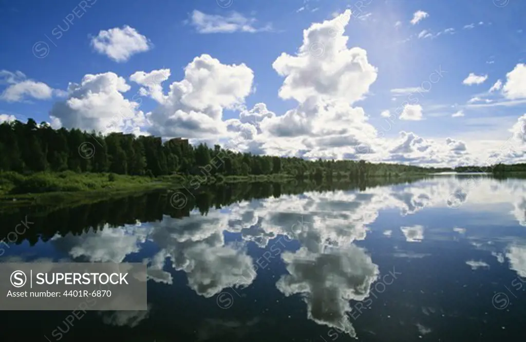 Clouds reflecting on the surface of the water, Lapland, Sweden.