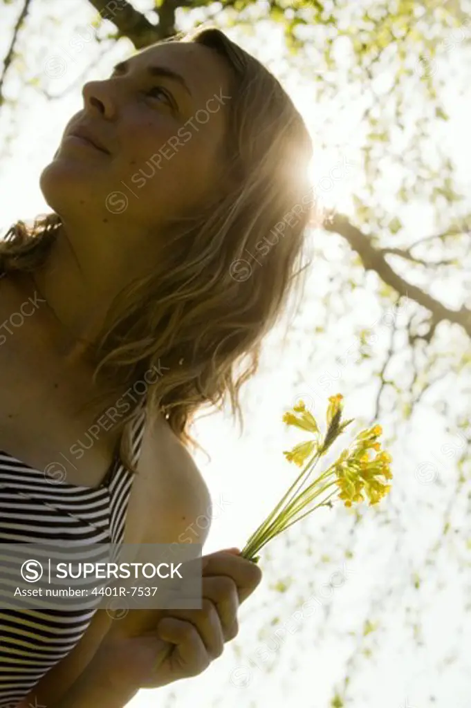 Portrait of s woman smelling a flower.