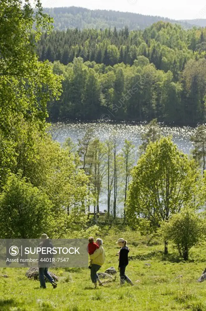 People walking on a meadow, Sweden.