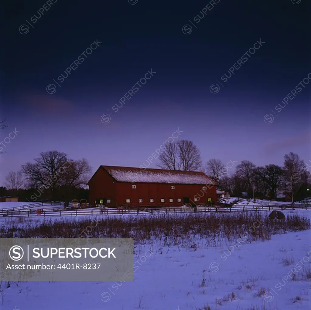 Farmhouse in snowy landscape