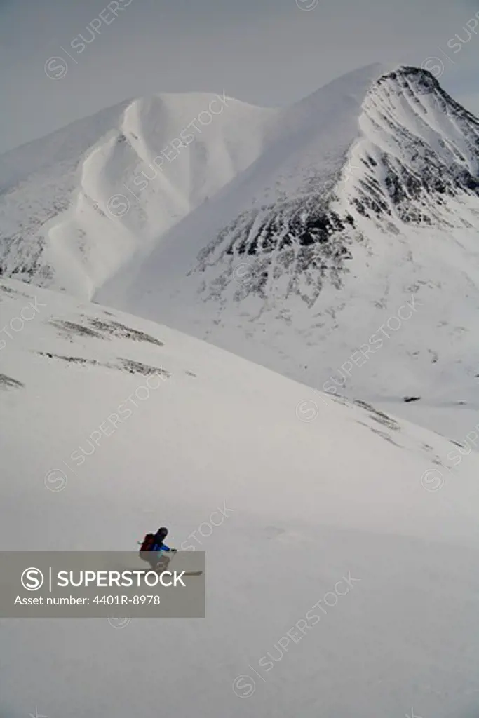 Telemark skier going downhill, Lapland, Sweden.