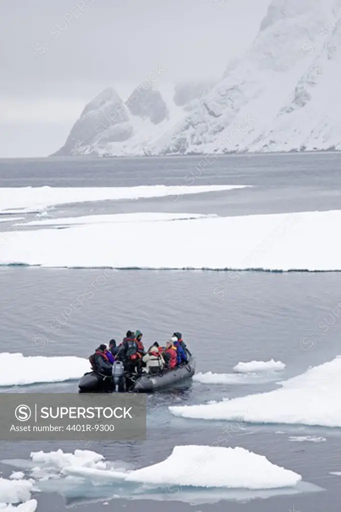 Small boat cruising between ice