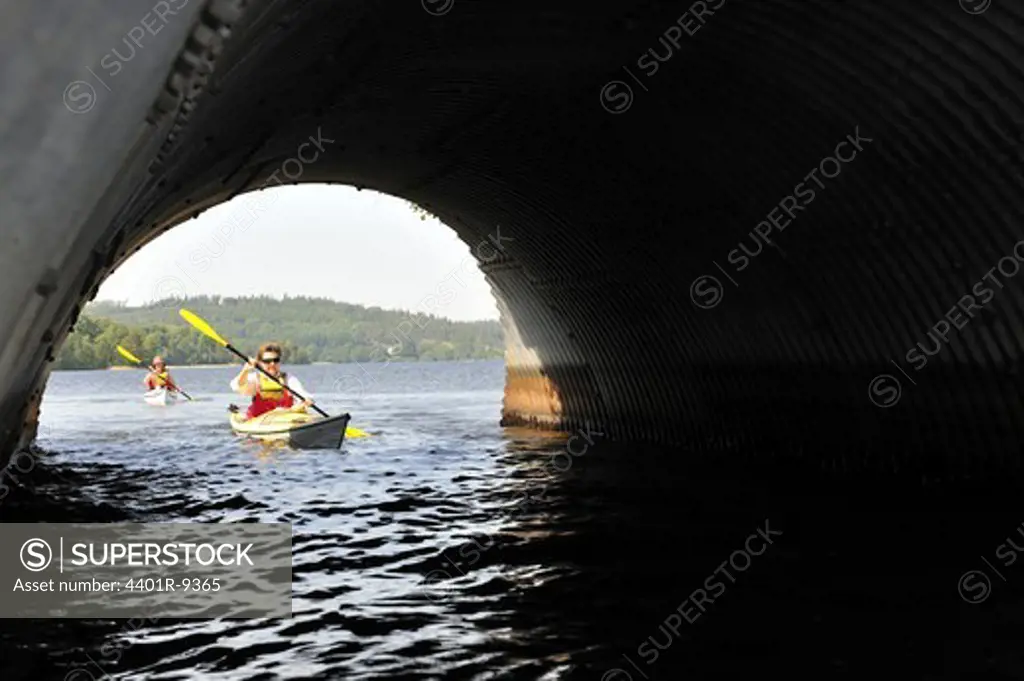 Kayak paddling in a tunnel, Ostergotland, Sweden.