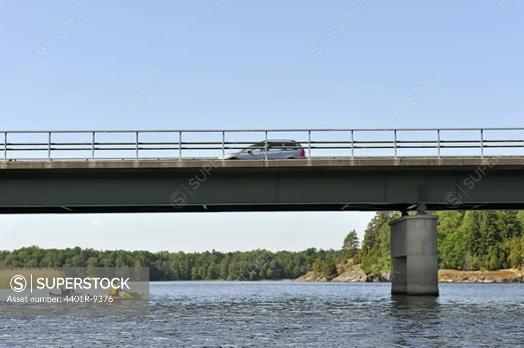 Kayak paddling under a bridge,  Ostergotland, Sweden.