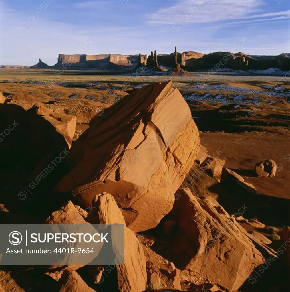 Rocks on landscape with cliffs in background