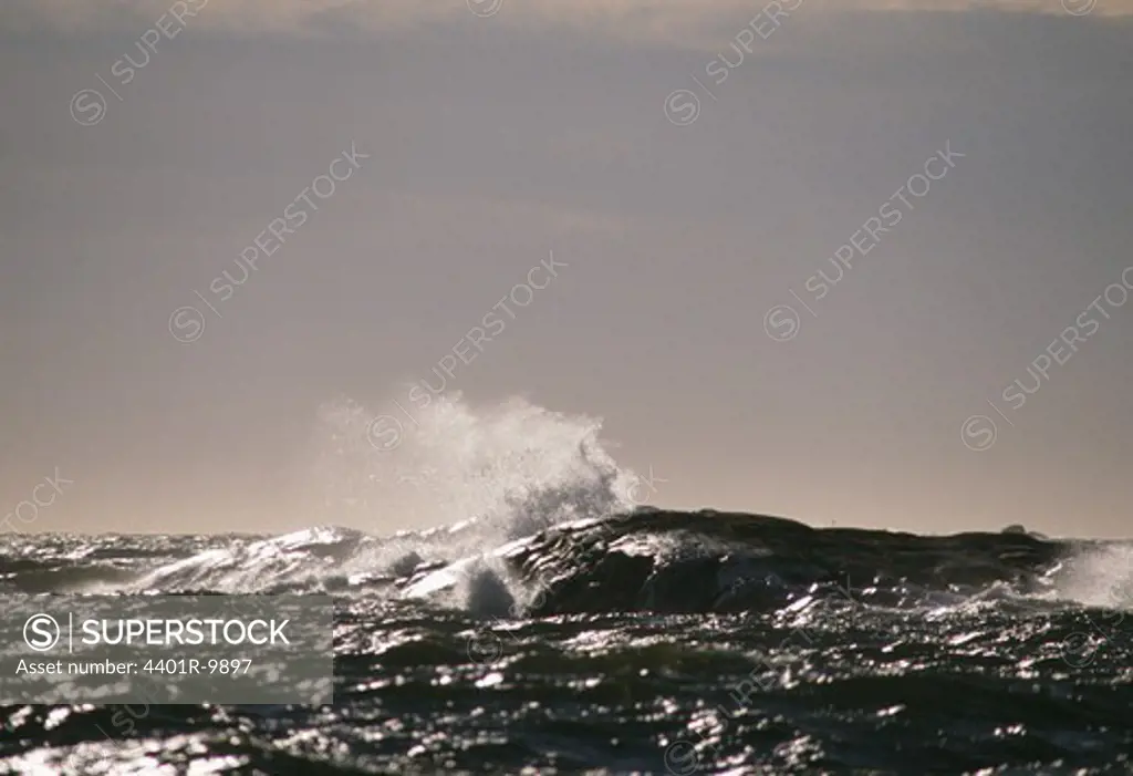 View of waves crashing against rock