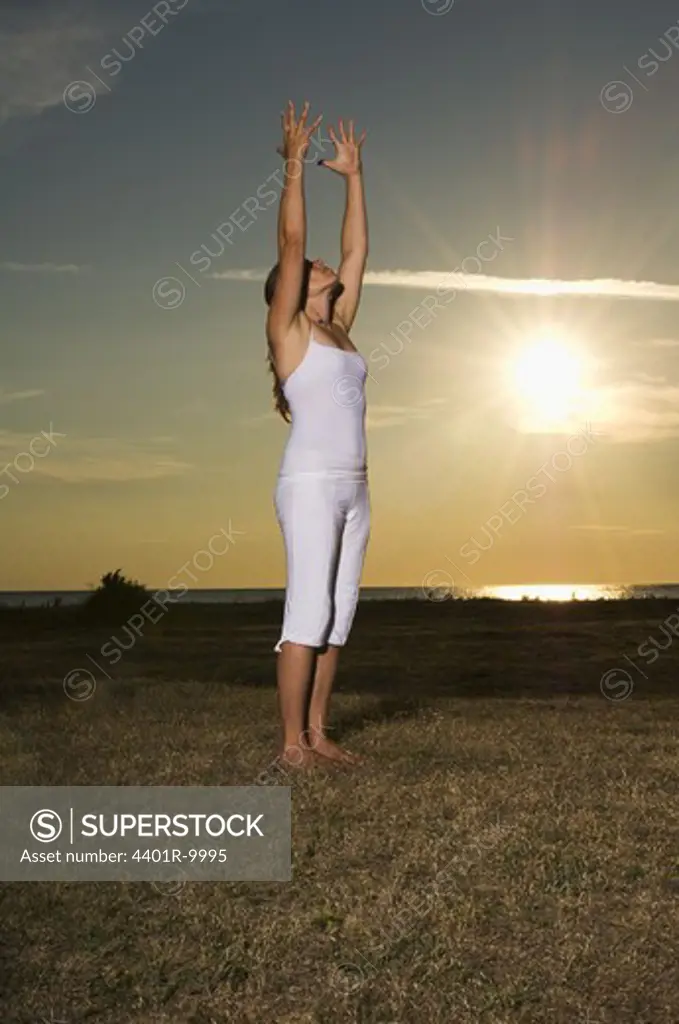 A woman doing yoga, Gotland, Sweden.