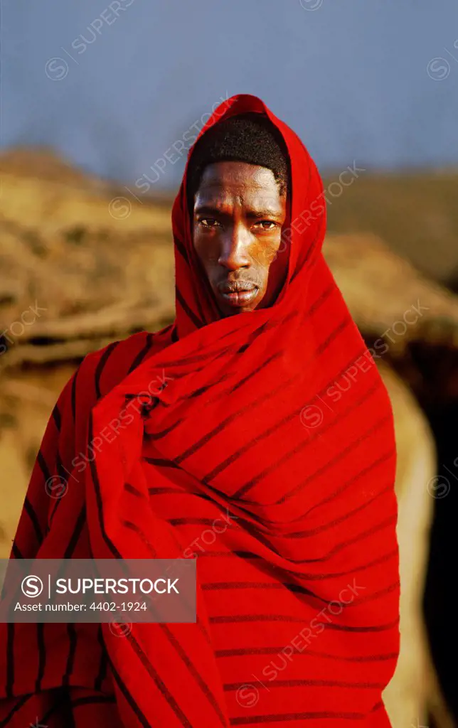 Maasai man wrapped in traditional red blanket, Kenya
