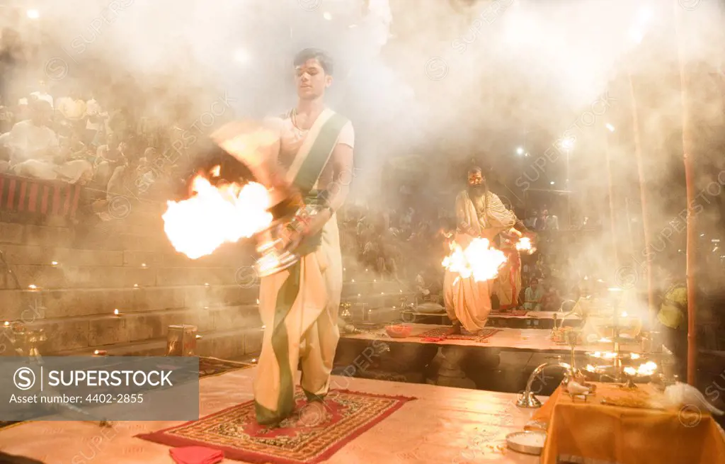 Hindu holy men performing religious ceremony (puja), Varanasi, India