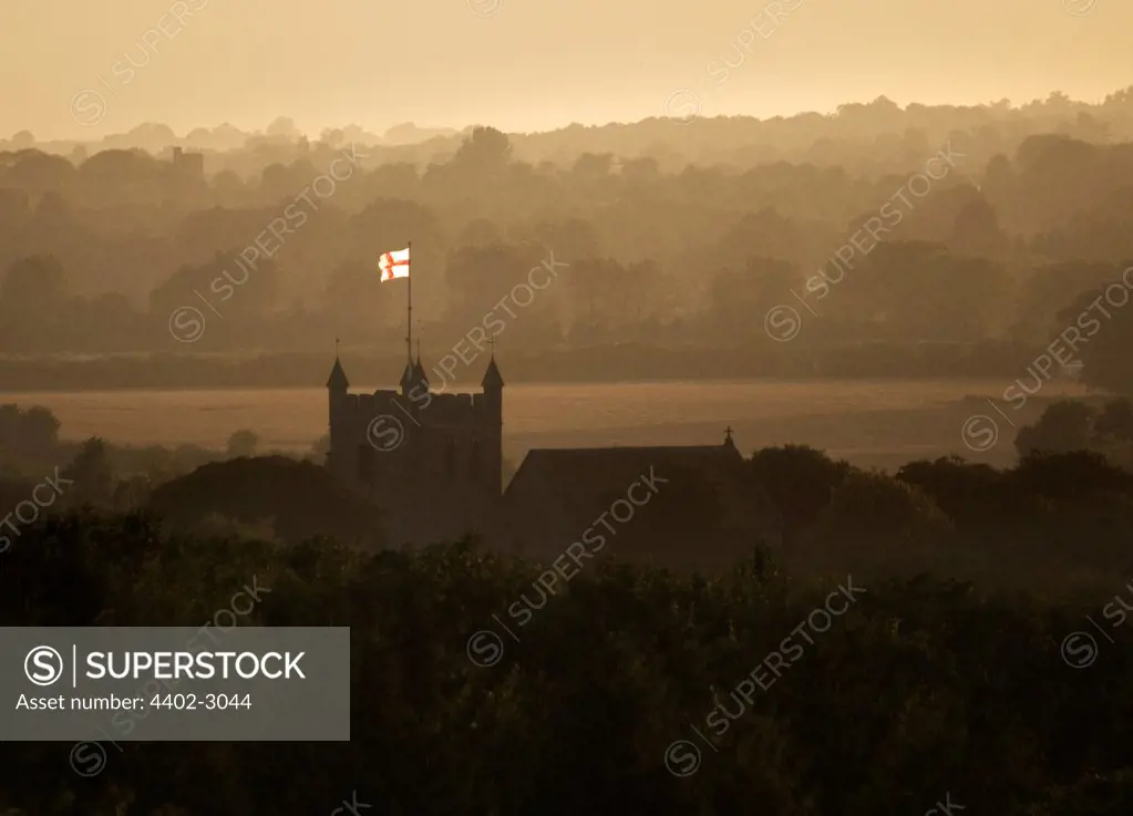 Flag flying on the church at dusk, Wye village, Kent
