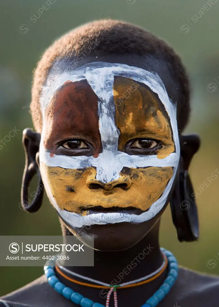 Suri girl with clay painted face, Omo Delta, Ethiopia