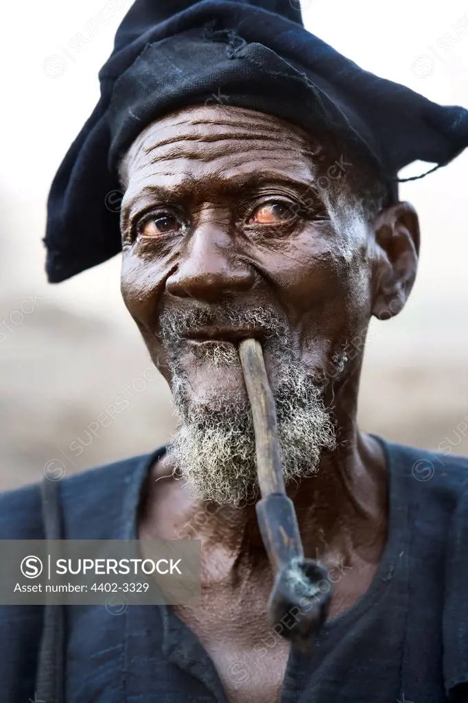 Dogon man smoking a pipe, Dogon Country, Mali