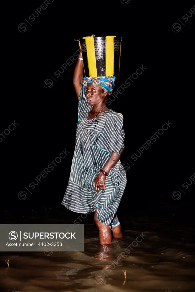 Woman collecting water in the River Niger, Mopti, Mali