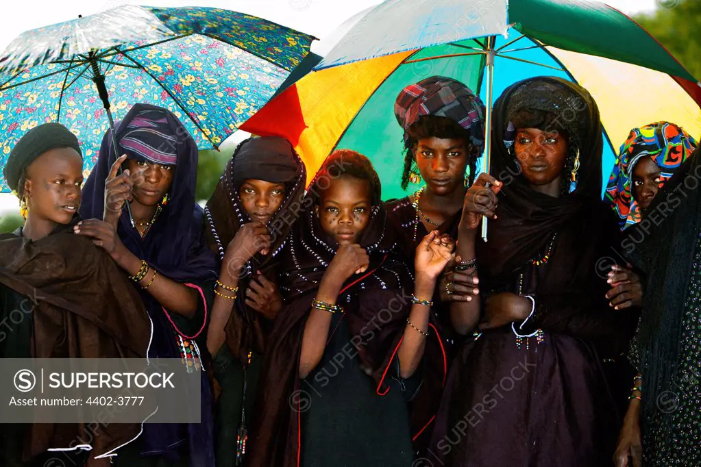 Wodaabe women shielding from the sun at the Gerewol Festival, north of Abalak, Niger