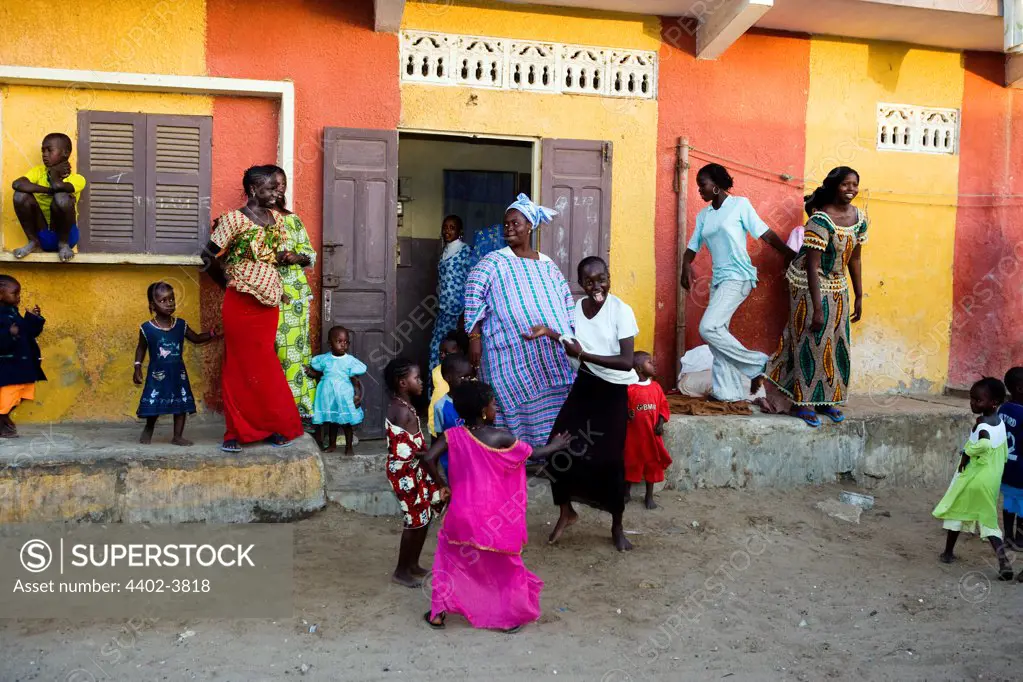 People dancing as a street parade passes by, St. Louis, Senegal, West Africa