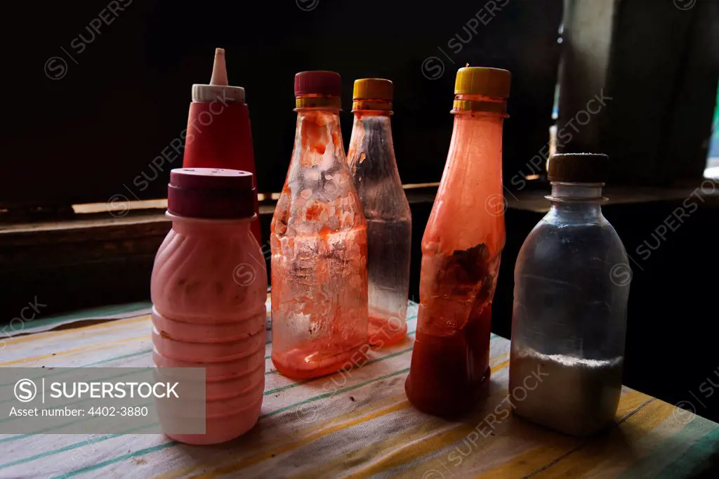 Tomato ketchup and vinegar bottles in fish and chips shop, Nairobi, Kenya.