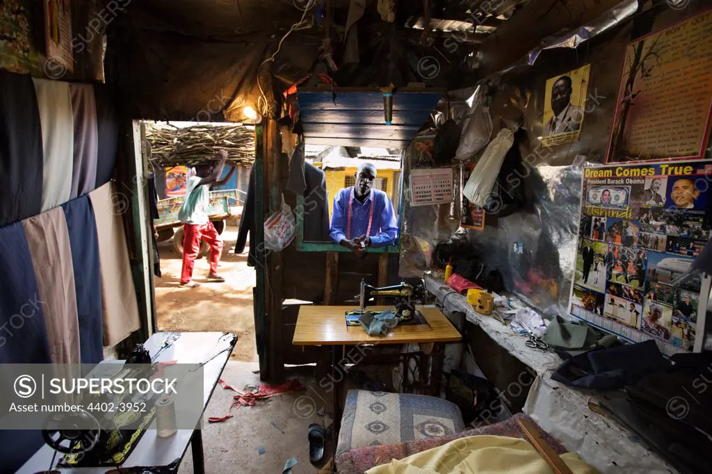 Jared Duma looking through the window of the Hope Tailoring Shop, Nairobi, Kenya.