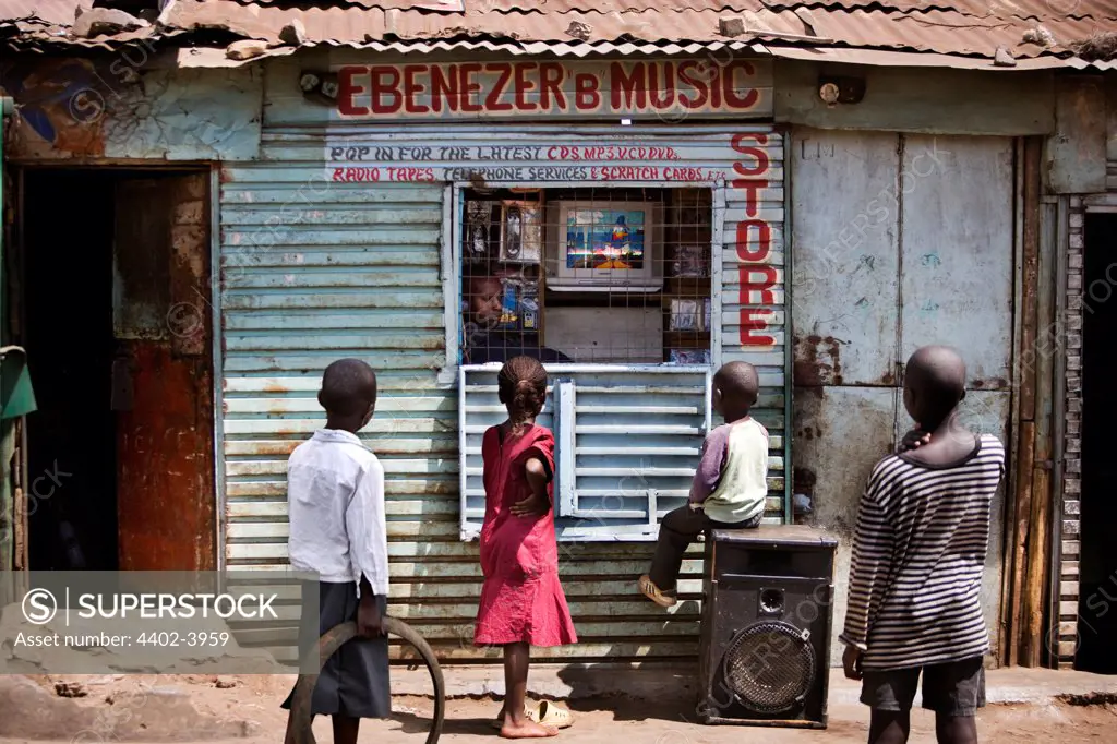 Children watching television in the window of Ebenezer B Music Store, Nairobi, Kenya.