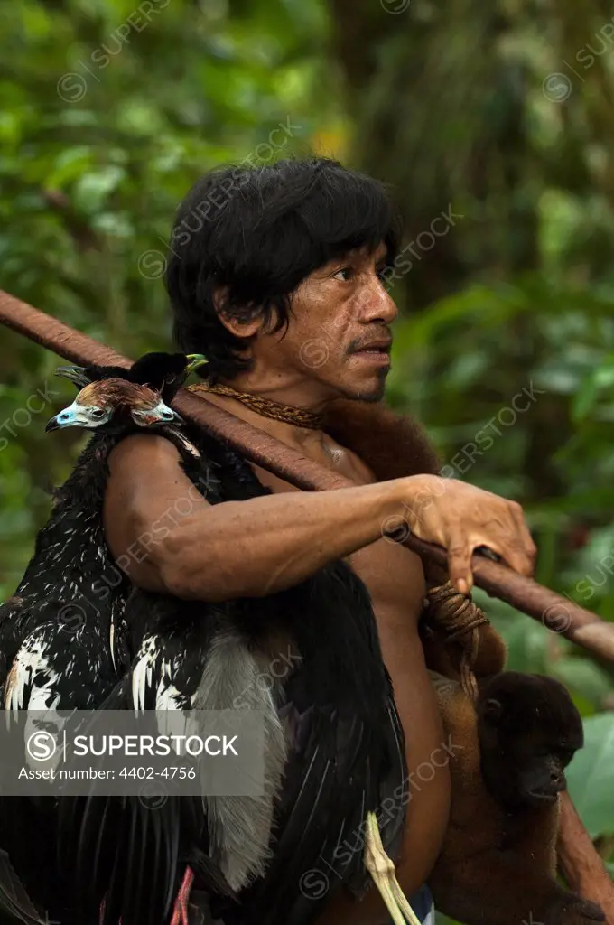Huaorani Indian, Oña Yate, with monkeys and birds he has hunted with his blowgun. Gabaro Community, Yasuni National Park, Amazon rainforest, Ecuador, South America.
