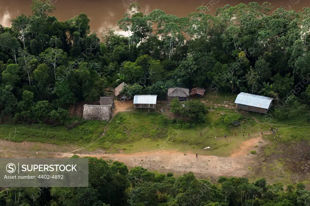 Huaorani Houses seen from the air; simple structures built directly on the ground with a frame made from thin branches covered with palm leaves. Bameno Community, Yasuni National Park, Amazon rainforest, Ecuador, South America.