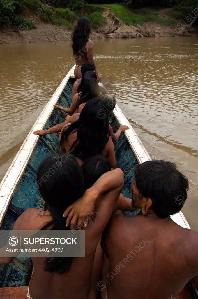 Huaorani Indians in motor canoe. Bameno Community, Yasuni National Park, Amazon rainforest, Ecuador, South America.