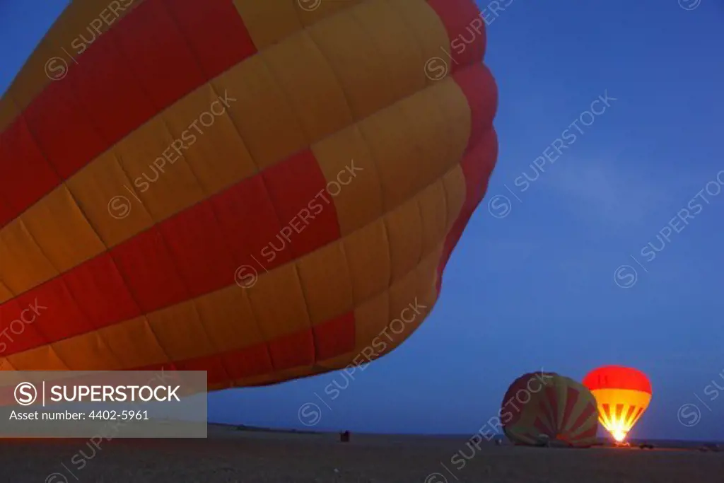 Safari hot-air balloons being inflated, Masai Mara, Kenya
