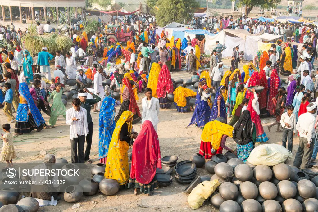 Local market busy with traders selling earthenware water pots and cooking utensils and sugar cane Rajasthan India